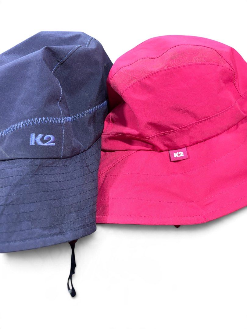 K2 GORE-TEX Technical Outdoor Bucket Hat (Category: Activewear) located in Iloilo. Submitted by oddforest.c9c7d5 (Listing ID 1467648687, Image 2). Description: - Brand: K2 - Size: M - Set of 2: Navy blue (abstract graphic print) and bright pink - Material: 100% polyester with GORE-TEX waterproof construction - Features: Adjustable chin strap with toggle for a secure fit - Style: Outdoor gear, practical and stylish.