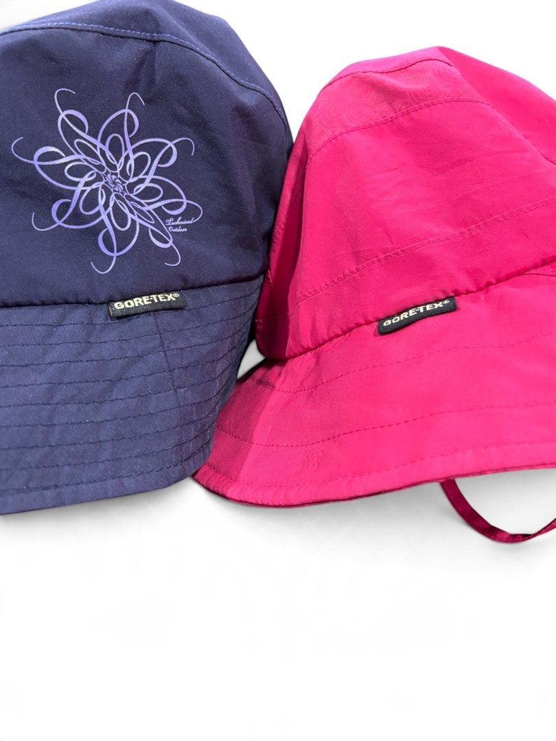 K2 GORE-TEX Technical Outdoor Bucket Hat (Category: Activewear) located in Iloilo. Submitted by oddforest.c9c7d5 (Listing ID 1467648687, Image 1). Description: - Brand: K2 - Size: M - Set of 2: Navy blue (abstract graphic print) and bright pink - Material: 100% polyester with GORE-TEX waterproof construction - Features: Adjustable chin strap with toggle for a secure fit - Style: Outdoor gear, practical and stylish.