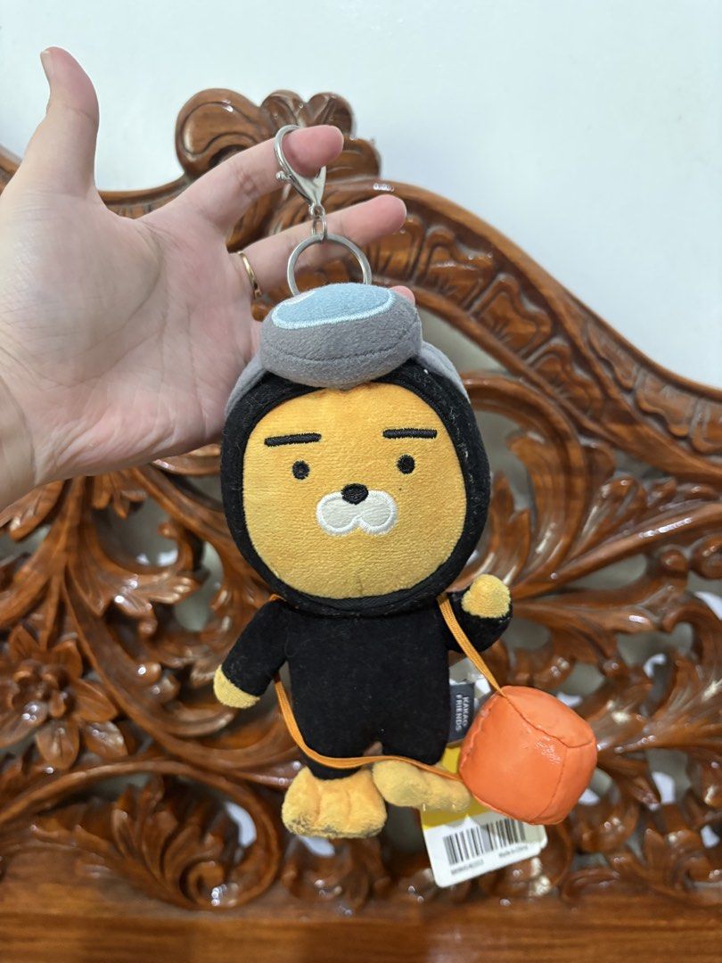 Kakao Friends Ryan Diver Plush Keychain (Category: Plushies & Soft Toys) located in Quezon City. Submitted by rxyel (Listing ID 1467658211, Image 2). Description: - Character: Kakao Friends Ryan - Design: Scuba diver in black wetsuit, gray hood, and orange oxygen tank - Condition: Brand new with original paper hang tag and fabric brand label - Attachment: Sturdy metal keyring included - Color: Yellow and black theme - 100% Authentic and official 
