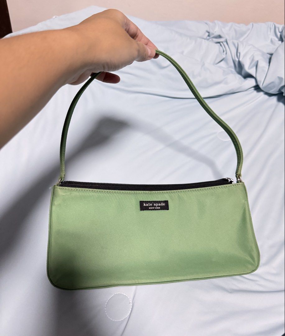 Kate Spade Green Nylon Pochette (Category: Luxury Bags & Wallets) located in Quezon City. Submitted by thriftream (Listing ID 1467711024, Image 2). Description: - Brand: Kate Spade - Style: Single-strap shoulder bag / Everyday carry - Material: Durable nylon in sage green - Closure: Top zip closure - Interior: Black fabric lining with a convenient zippered pocket - Condition: Minor wear near the zipper area, otherwise in great usable condition.
