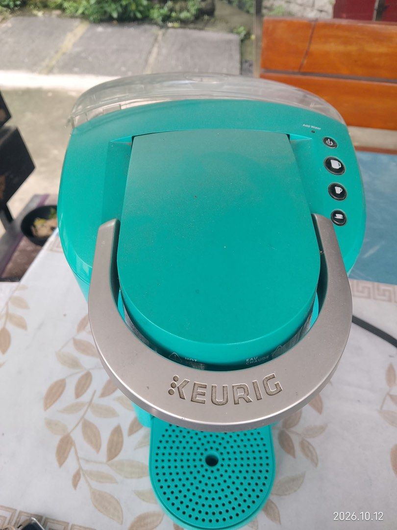 Keurig Coffee Maker Teal Blue Single Serve (Category: Coffee Machines & Makers) located in Quezon City. Submitted by mjgaudier (Listing ID 1467614025, Image 1). Description: - Color: Bright teal - Type: Single-serve coffee maker - Compatibility: Works with standard coffee pods - Included: Water reservoir with filter attachment and drip tray - Features: Easy-to-open needle housing, simple top-panel power and cup size buttons - Condition: Clean bod