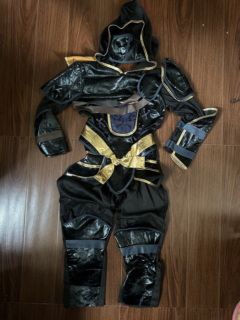 Kids Ninja Costume (Category: Babies & Kids Fashion) located in Quezon City. Submitted by kamrivera (Listing ID 1467646269, Image 1). Description: - Kids ninja costume in a cool black and gold design - Complete set includes hooded top, trousers, shoulder armor, and gold waist sash NO SWORD - Features stylish shiny faux leather panels on sleeves and shins - Perfect for Halloween, costume parties, and roleplay Size 7-8 Used once for Halloween..