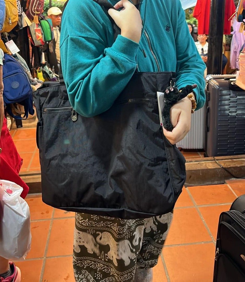 Kipling Black Tote Bag with Monkey Keychain (Category: Tote Bags) located in Pasay City. Submitted by mavie527 (Listing ID 1467618240, Image 1). Description: - Brand: Kipling (Brand new with tags attached) - Color: Classic Black - Features: Secure zip closure, front zippered pocket, and side interior zip pocket - Inclusions: Signature Kipling furry monkey keychain charm - Material: Durable, lightweight, and easy-to-wipe synthetic fabric - Versati