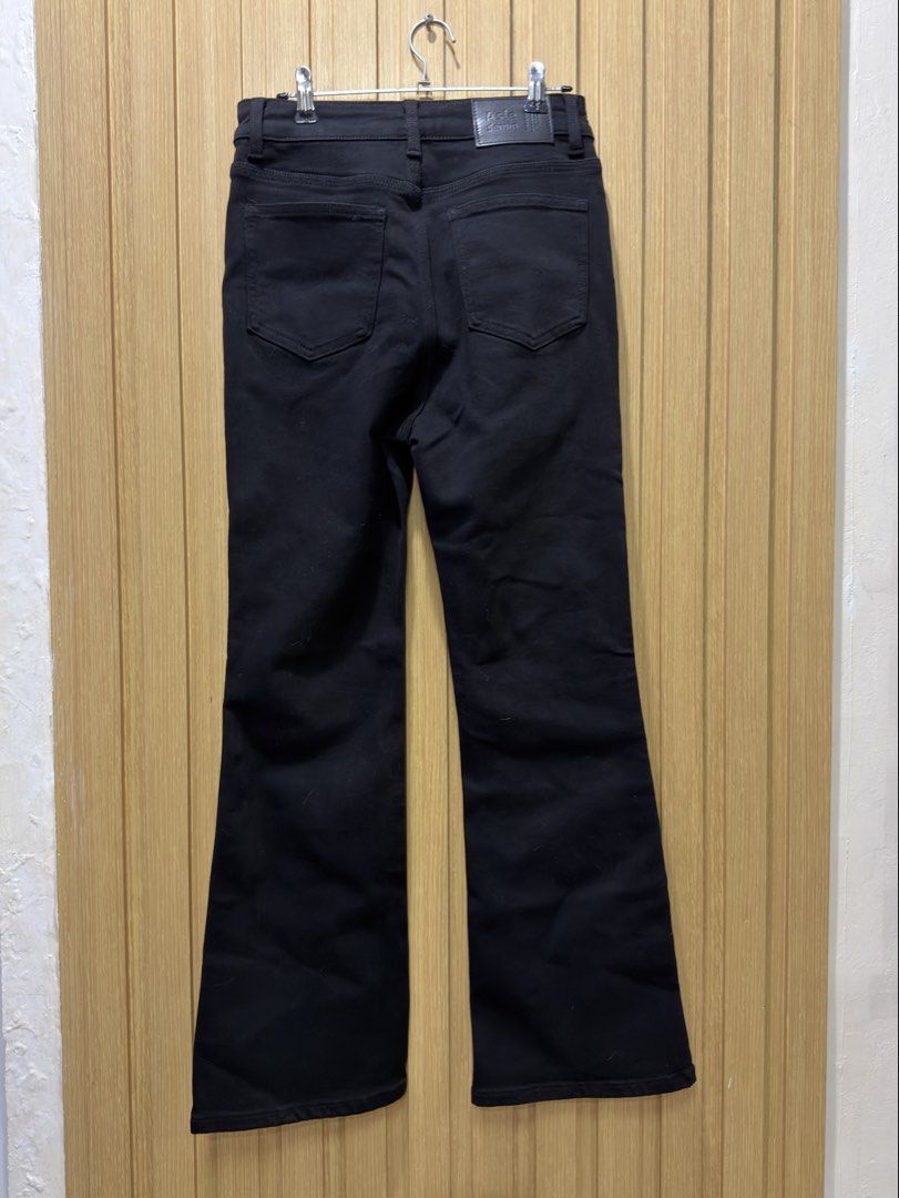 KS Denmo Black denim flare pants size 27 (Category: Jeans) located in Bacoor. Submitted by preloved_with_love_ (Listing ID 1467610271, Image 2). Description: - Color: Solid black - Size: 27 - Fit: High-rise with a flattering flare - Closure: Front button and zipper - Pockets: Classic five-pocket style with back patch pockets - Material: 75% viscose, 20% polyester, 3% viscose blend, 2% spandex (has stretch) - Condition: Clean dark wash finish.