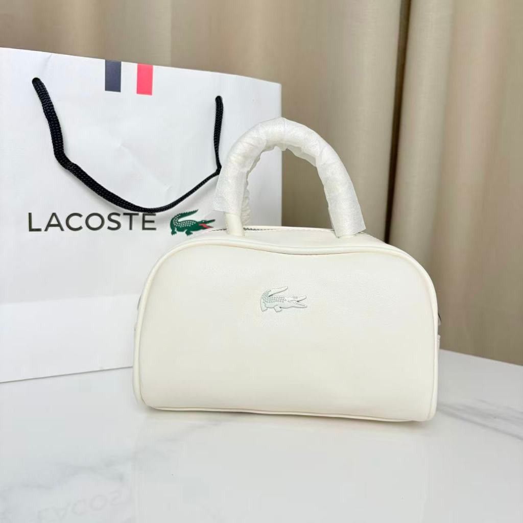 Lacoste Barrel Bag Crossbody Bag (Category: Cross-body Bags) located in Caloocan City. Submitted by luckyocean_e40f38 (Listing ID 1467664219, Image 2). Description: - Brand new Lacoste barrel bag with matching paper bag - Structured, compact daily-use design in solid colors - Dual top handles wrapped in protective film - Adjustable fabric shoulder strap with durable metal hardware - Perfect for casual outings and everyday essentials.