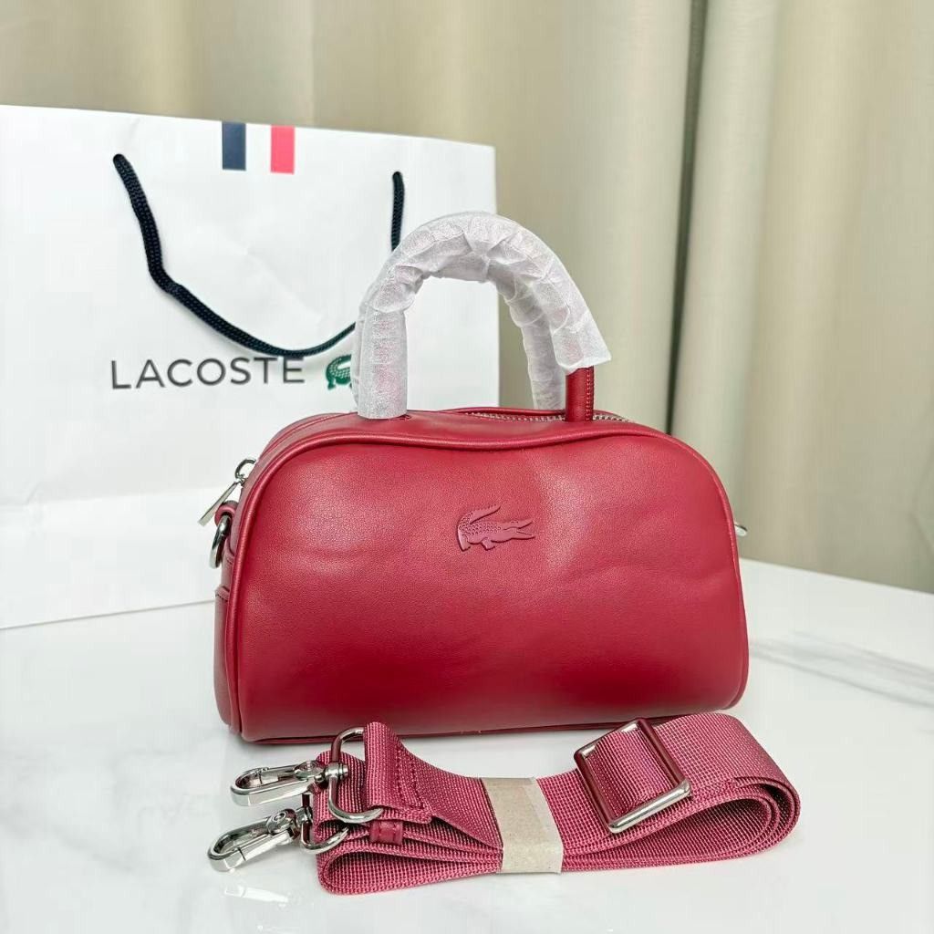 Lacoste Barrel Bag Crossbody Bag (Category: Cross-body Bags) located in Caloocan City. Submitted by luckyocean_e40f38 (Listing ID 1467664219, Image 1). Description: - Brand new Lacoste barrel bag with matching paper bag - Structured, compact daily-use design in solid colors - Dual top handles wrapped in protective film - Adjustable fabric shoulder strap with durable metal hardware - Perfect for casual outings and everyday essentials.