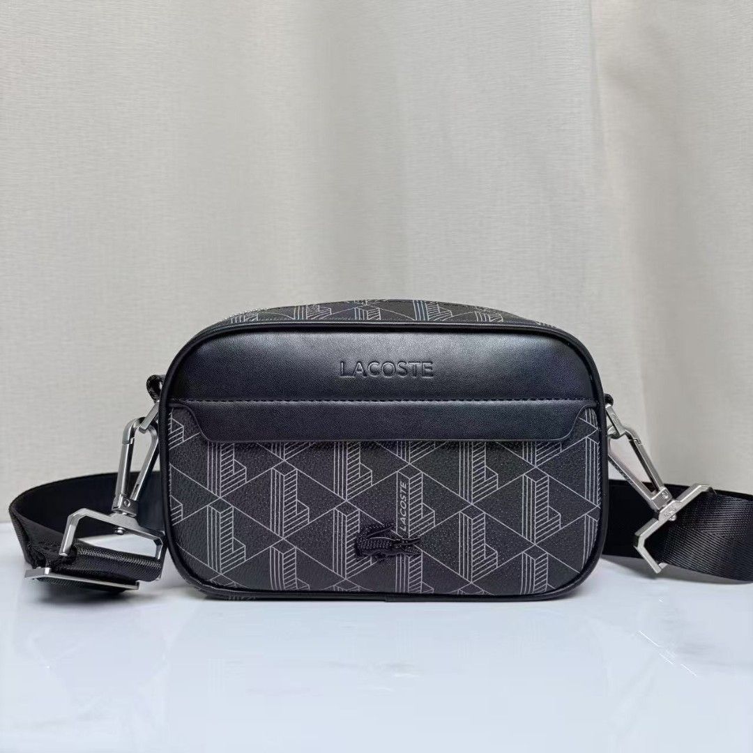 Lacoste Black Geometric Pattern Crossbody Bag (Category: Sling Bags) located in Caloocan City. Submitted by luckyocean_e40f38 (Listing ID 1467664473, Image 1). Description: - Brand: Lacoste - Style: Compact crossbody / camera bag - Color: Classic black - Design: Geometric monogram body with solid black leather flap - Branding: Embossed Lacoste lettering and iconic metal crocodile logo - Strap: Adjustable black strap with silver-tone hardware clip