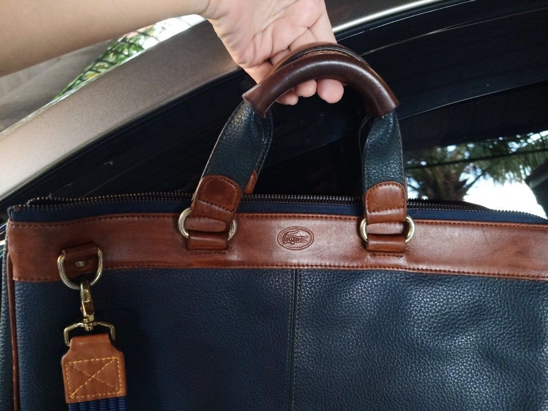 Lacoste blue 2way office bag (Category: Cross-body Bags) located in Cainta. Submitted by allauthenticbymj (Listing ID 1467722138, Image 3). Description: Lacoste 2way office bag color:blue L15.5"/H11.5"/W3.5" issue: 4bottom corners of the bag price:4,800 Location: Cainta.