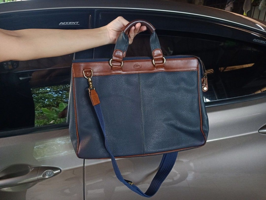 Lacoste blue 2way office bag (Category: Cross-body Bags) located in Cainta. Submitted by allauthenticbymj (Listing ID 1467722138, Image 2). Description: Lacoste 2way office bag color:blue L15.5"/H11.5"/W3.5" issue: 4bottom corners of the bag price:4,800 Location: Cainta.