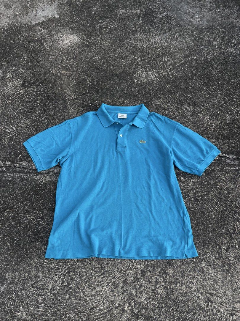 Lacoste Blue Polo Shirt Size 110 (Category: Tshirts & Polo Shirts ) located in Tarlac. Submitted by supremo.0 (Listing ID 1467679834, Image 1). Description: - Brand: Lacoste - Color: Bright Blue - Size: 110 XL (23x27) - Material: 100% Cotton (comfortable & breathable) - Details: Classic collar, 2-button placket, short sleeves - Logo: Iconic green crocodile on chest - Style: Versatile casual top, easy to match with jeans or shorts - Condition: Gre