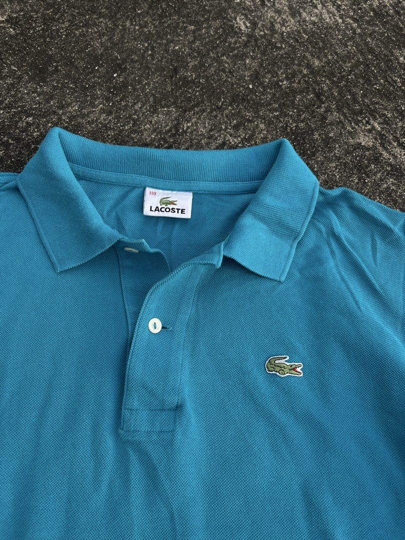 Lacoste Blue Polo Shirt Size 110 (Category: Tshirts & Polo Shirts ) located in Tarlac. Submitted by supremo.0 (Listing ID 1467679834, Image 2). Description: - Brand: Lacoste - Color: Bright Blue - Size: 110 XL (23x27) - Material: 100% Cotton (comfortable & breathable) - Details: Classic collar, 2-button placket, short sleeves - Logo: Iconic green crocodile on chest - Style: Versatile casual top, easy to match with jeans or shorts - Condition: Gre