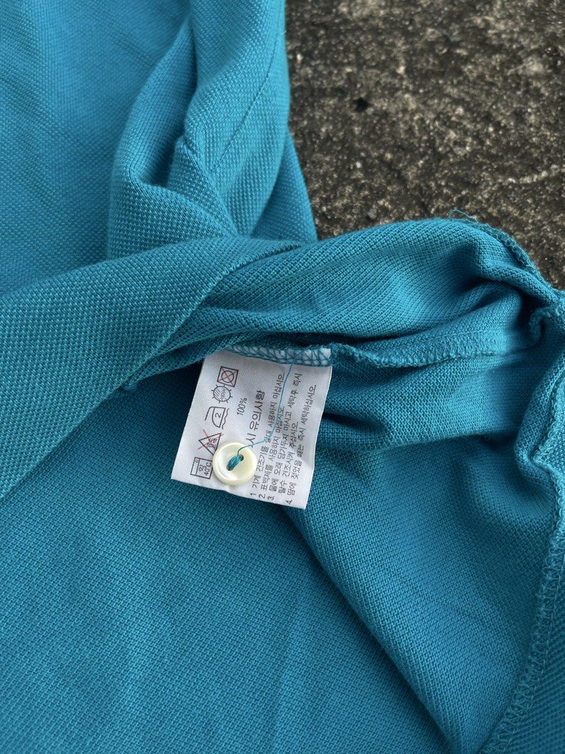 Lacoste Blue Polo Shirt Size 110 (Category: Tshirts & Polo Shirts ) located in Tarlac. Submitted by supremo.0 (Listing ID 1467679834, Image 3). Description: - Brand: Lacoste - Color: Bright Blue - Size: 110 XL (23x27) - Material: 100% Cotton (comfortable & breathable) - Details: Classic collar, 2-button placket, short sleeves - Logo: Iconic green crocodile on chest - Style: Versatile casual top, easy to match with jeans or shorts - Condition: Gre