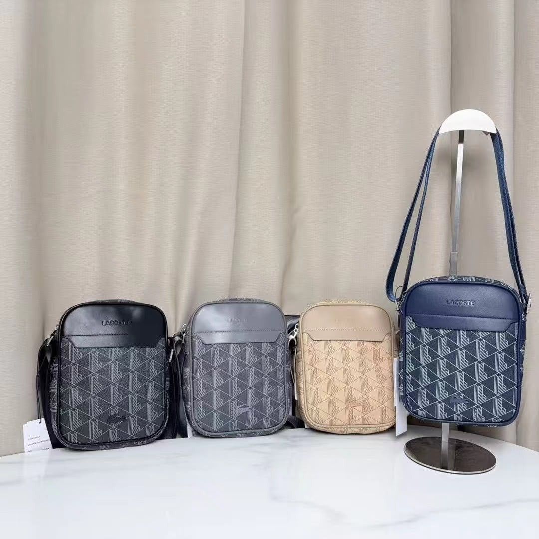 Lacoste Monogram Crossbody Bag Various Colors (Category: Sling Bags) located in Caloocan City. Submitted by luckyocean_e40f38 (Listing ID 1467666544, Image 1). Description: - Brand: Lacoste - Style: Crossbody bag with geometric monogram pattern - Details: Solid top flap with stamped Lacoste logo, adjustable long strap, and tags attached - Colors Available: Black, Grey, Beige, Blue - Condition: Brand new with tags - Mode of Payment: GCash, BPI, or