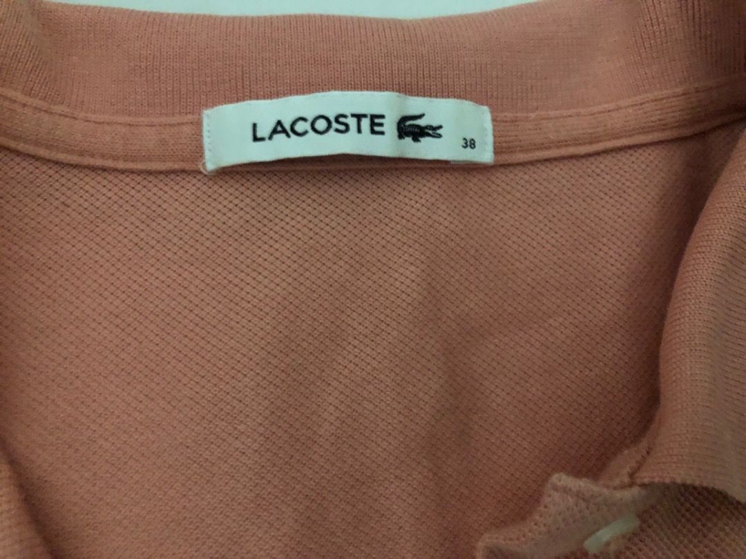 Lacoste Pink Polo Shirt Size 38 (Category: Tshirts & Polo Shirts ) located in Manila. Submitted by kissa.1890 (Listing ID 1467737519, Image 2). Description: - 100% Authentic Lacoste polo shirt - Color: Soft Pink - Size: 38 (verified on inner label) - Classic collar design with button placket - Textured fabric construction with ribbed collar - Great for daily wear or smart casual outings - Condition: Excellent.