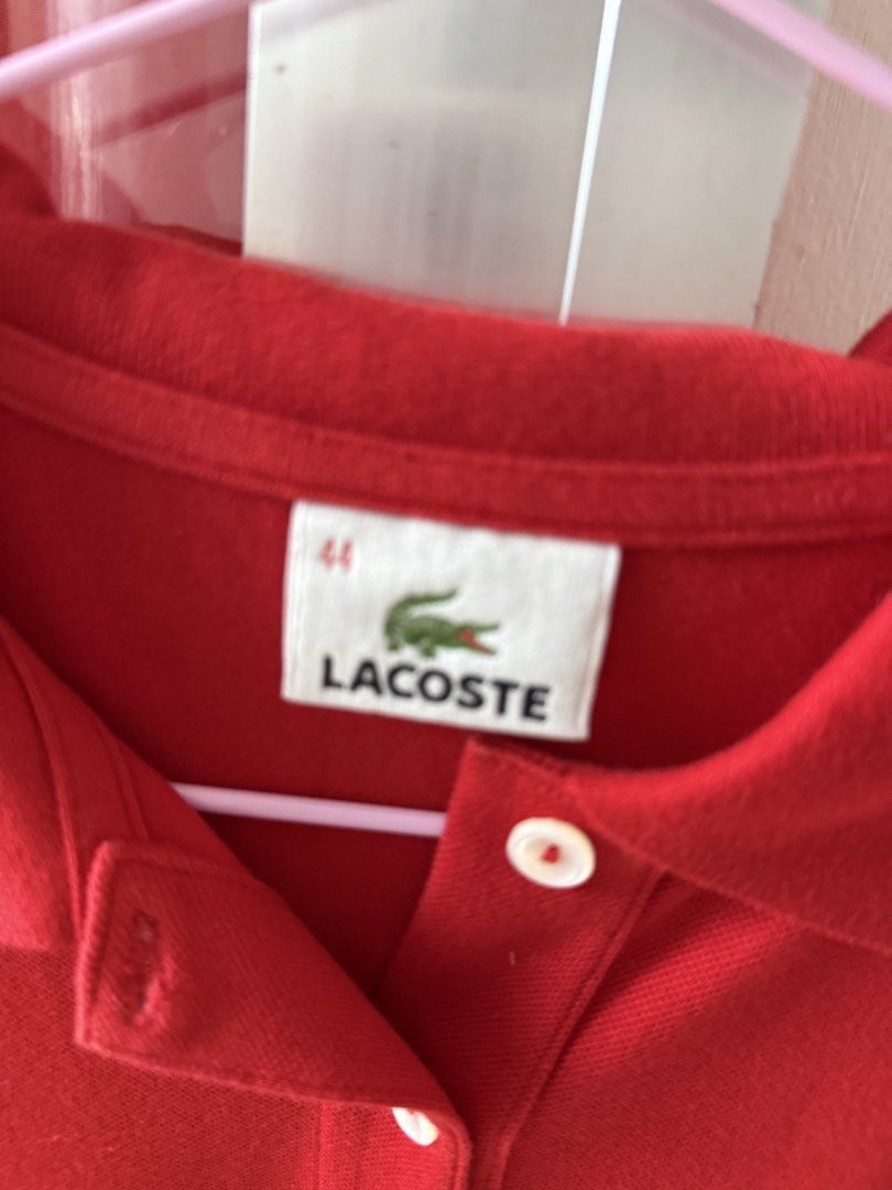 Lacoste Red Polo Shirt Size 44 (Category: Shirts) located in Mandaluyong City. Submitted by declutteringmylife101 (Listing ID 1467629341, Image 2). Description: - Brand: Lacoste - Color: Bright Red - Size: 44 - Material: Soft, breathable cotton - Features: Classic collar with two white buttons, short sleeves with ribbed cuffs, and embroidered green crocodile logo on the chest - Condition: Clean and ready to wear - Ideal for: Casual outings or spo