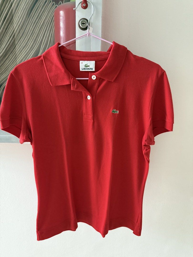 Lacoste Red Polo Shirt Size 44 (Category: Shirts) located in Mandaluyong City. Submitted by declutteringmylife101 (Listing ID 1467629341, Image 1). Description: - Brand: Lacoste - Color: Bright Red - Size: 44 - Material: Soft, breathable cotton - Features: Classic collar with two white buttons, short sleeves with ribbed cuffs, and embroidered green crocodile logo on the chest - Condition: Clean and ready to wear - Ideal for: Casual outings or spo