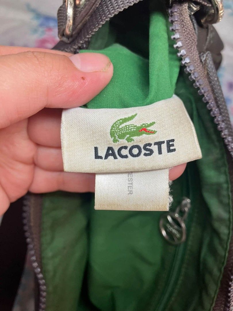 Lacoste Shoulder Bag (Category: Shoulder Bags) located in Manila. Submitted by boldfire_315559 (Listing ID 1467660649, Image 3). Description: - Brand: Lacoste - Color: Classic Brown with vibrant green interior lining - Style: Structured shoulder bag with adjustable strap and metal hardware - Features: Convenient inner zip pocket and iconic embroidered crocodile logo - Size: Compact and practical for daily errands - Condition: Well-maintained and 