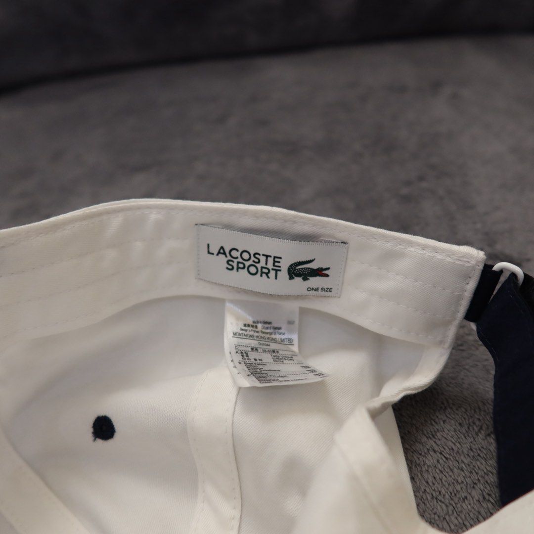 Lacoste Sport White Tennis Cap (Category: Caps & Hats) located in Manila. Submitted by gentlewind_62f064 (Listing ID 1467616936, Image 3). Description: - Brand: Lacoste Sport - Model: TH1044 - Color: White with navy blue embroidered branding - Logo: Iconic green crocodile patch on the side - Size: One size fits all (adjustable strap in the back) - Condition: Clean inside and out, ready to wear.