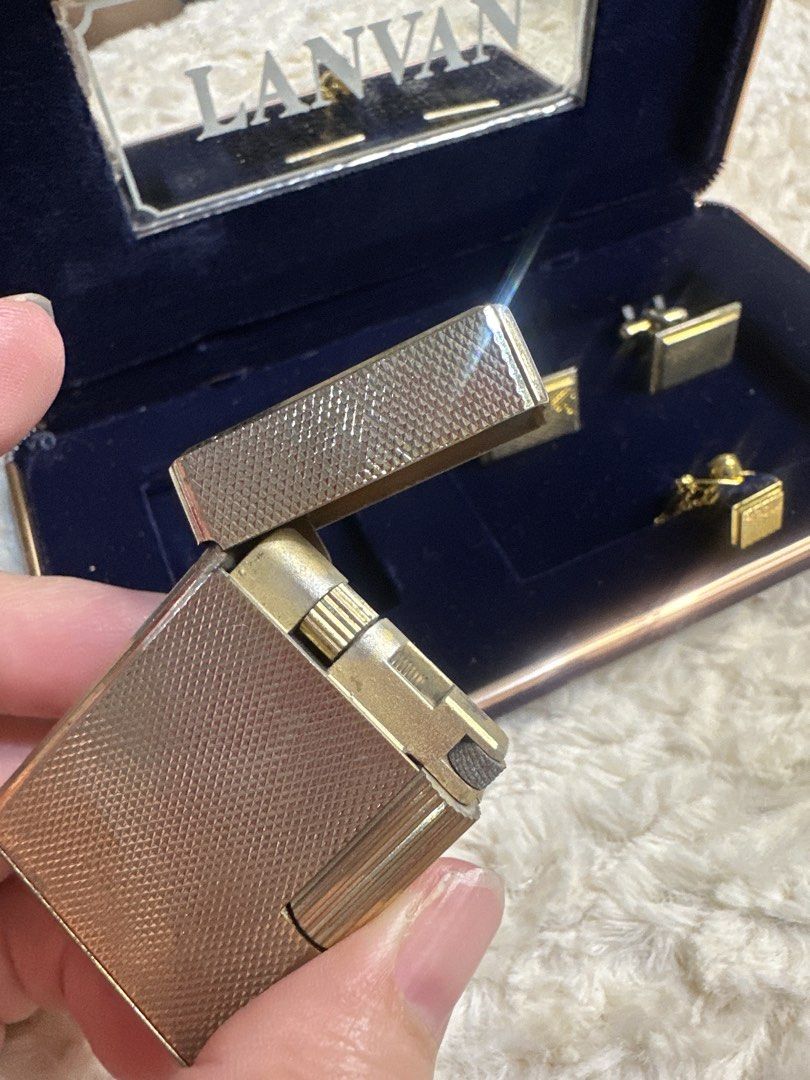 Lanvan Lighter and Cufflinks Set with Box (Category: Luxury Accessories) located in Antipolo. Submitted by prelovedcloseta (Listing ID 1467605776, Image 3). Description: - Authentic vintage Lanvan set including a gold-tone lighter, matching cufflinks, and a tie tack - Features an elegant textured geometric pattern across all metal surfaces - Comes in its original navy blue presentation box with a built-in branded mirror - Excellent collector's it