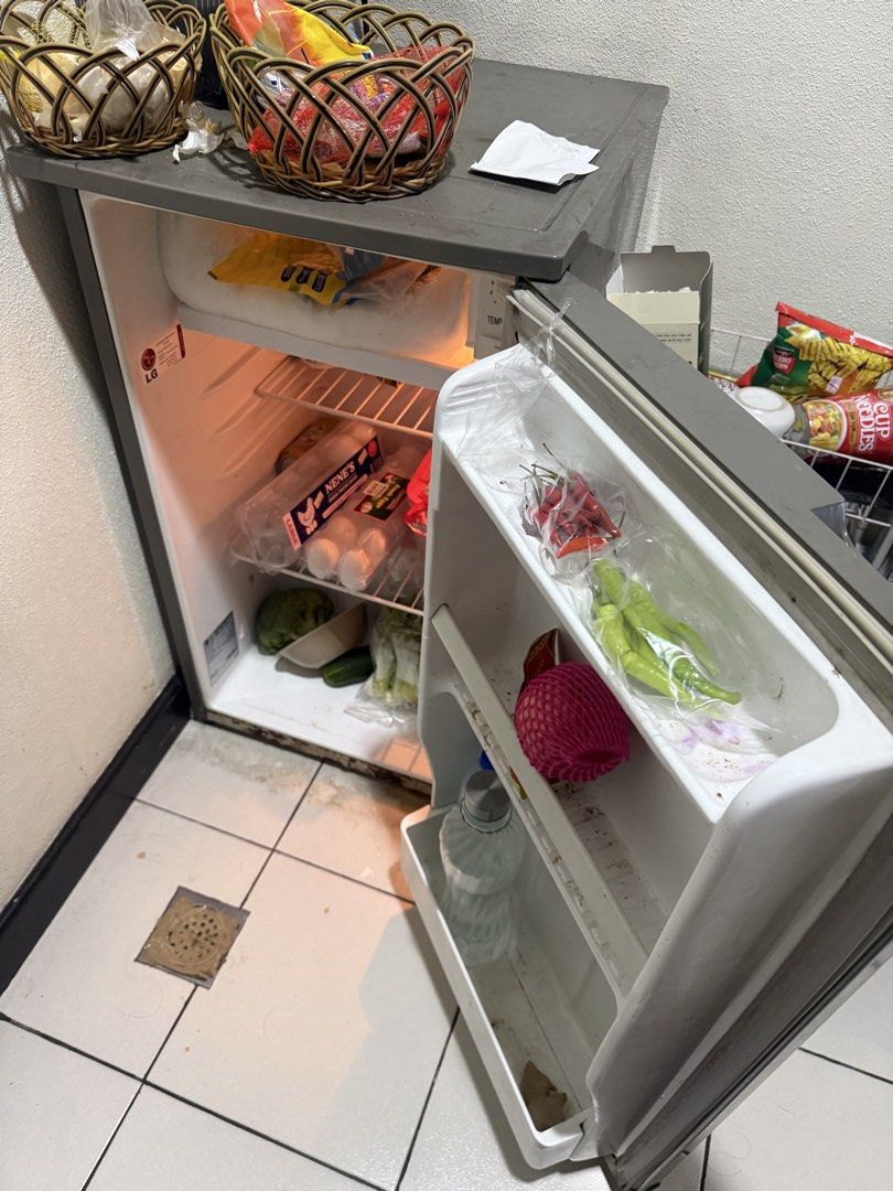 LG compact mini fridge with small freezer compartment (Category: Refrigerators and Freezers) located in Manila. Submitted by sheldonjet (Listing ID 1467759189, Image 1). Description: - Brand: LG model GC-131SV2 compact fridge (Grey top, white body) - Condition: Used, works fine - Features: Interior wire shelf, door racks for bottles/produce, and a small top freezer section - Perfect for: Extra cooling space for a dorm, room, or office - Fulfillme