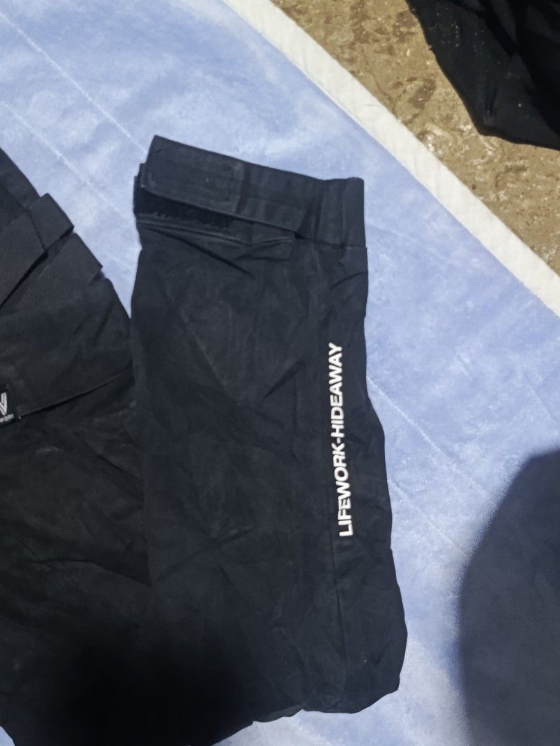 LifeWork Black Cargo Pants Medium (Category: Jeans) located in City of Isabela. Submitted by warmbird.d06e6f (Listing ID 1467637808, Image 3). Description: - Brand: LifeWork - Color: Black - Size: Medium - Style: Streetwear - Material: Durable cotton-blend - Features: Multiple utility pockets with straps, brand logo patches, text print down the leg - Fit: Adjustable drawstring waistband and Velcro ankle cuffs - Condition: Brand new / Excellent.