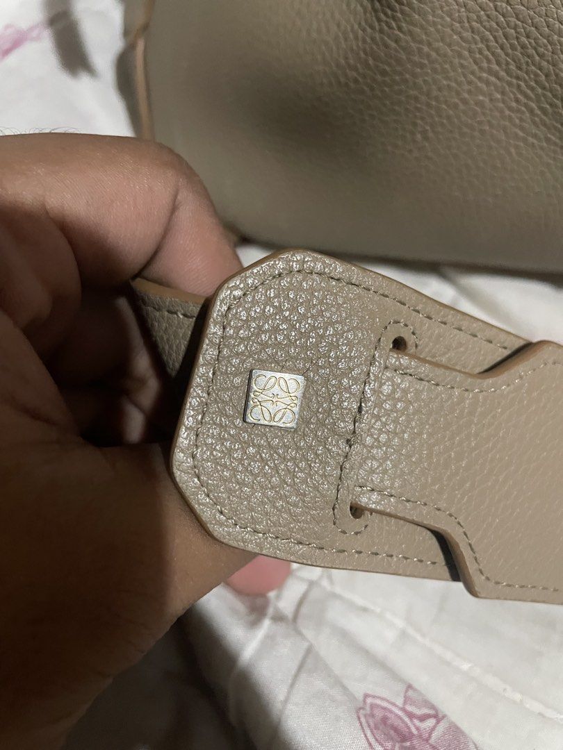 Loewe Puzzle Bag Taupe Leather (Category: Luxury Bags & Wallets) located in Davao. Submitted by houkaygoods (Listing ID 1467713114, Image 2). Description: Taupe pebbled leather Loewe Puzzle bag. Crafted in Spain with signature geometric paneling. Gold tone hardware, top handle, and adjustable shoulder strap. Interior lined in herringbone canvas with embossed logo patch and serial number tag. Zip closure along the top flap. Classic puzzle design f