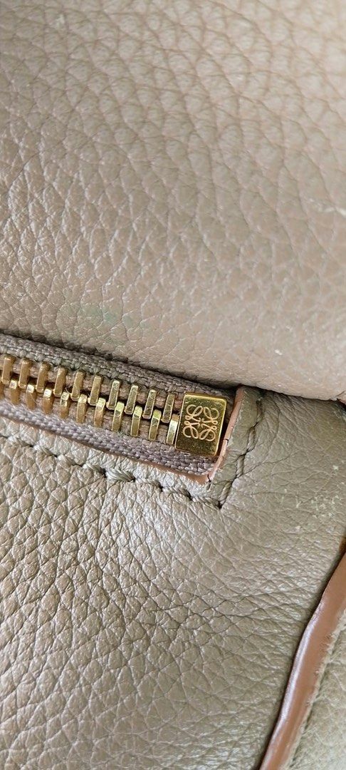 Loewe Puzzle Bag Taupe Leather (Category: Luxury Bags & Wallets) located in Davao. Submitted by houkaygoods (Listing ID 1467713114, Image 3). Description: Taupe pebbled leather Loewe Puzzle bag. Crafted in Spain with signature geometric paneling. Gold tone hardware, top handle, and adjustable shoulder strap. Interior lined in herringbone canvas with embossed logo patch and serial number tag. Zip closure along the top flap. Classic puzzle design f