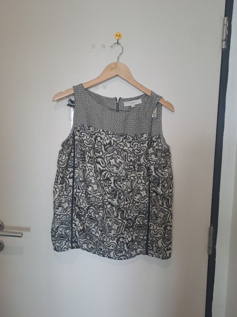 Loft by Anne Taylor sleeveless (Category: Sleeveless) located in Manila. Submitted by joanbalde39643 (Listing ID 1467659611, Image 1). Description: This is a women's sleeveless mixed-print blouse from the clothing brand LOFT. The shirt features a contrasting panel design with a small geometric or micro-floral pattern across the upper yoke and a classic black-and-white paisley print throughout the main body. It is accented with vertical black trim