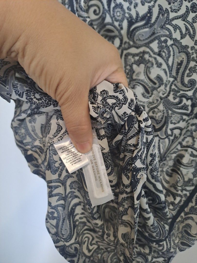 Loft by Anne Taylor sleeveless (Category: Sleeveless) located in Manila. Submitted by joanbalde39643 (Listing ID 1467659611, Image 3). Description: This is a women's sleeveless mixed-print blouse from the clothing brand LOFT. The shirt features a contrasting panel design with a small geometric or micro-floral pattern across the upper yoke and a classic black-and-white paisley print throughout the main body. It is accented with vertical black trim