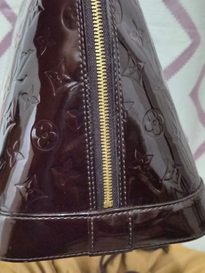 Louis Vuitton Alma Monogram Vernis Amarante Handbag (Category: Luxury Bags & Wallets) located in Caloocan City. Submitted by rmdesilva (Listing ID 1467735299, Image 3). Description: - Authentic Louis Vuitton Alma bag - Monogram Vernis leather in deep Amarante (glossy dark brown) - Structured dome shape with dual rolled top handles - Gold-tone hardware with double zip closure and LV pulls - Includes matching clochette with keys - Patent exterior i