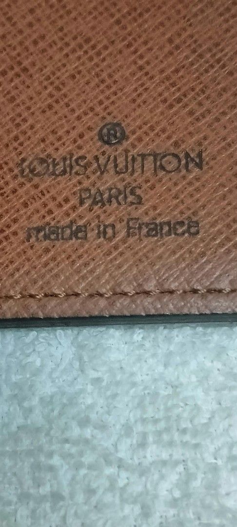 Louis Vuitton Monogram Checkbook Wallet (Category: Luxury Bags & Wallets) located in Agdangan. Submitted by lordie87 (Listing ID 1467616410, Image 2). Description: - Code CT1000 (OCT. 2000) - Authentic Louis Vuitton vertical wallet in classic dark brown monogram canvas - Made in France with clean, durable stitching along the edges and fold - Features multiple card slots and interior slip pockets for optimal organization - Slim billfold design hol