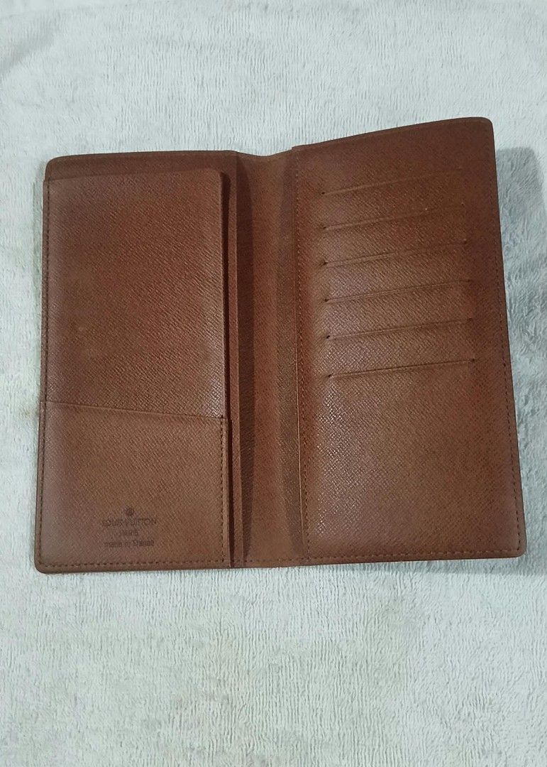 Louis Vuitton Monogram Checkbook Wallet (Category: Luxury Bags & Wallets) located in Agdangan. Submitted by lordie87 (Listing ID 1467616410, Image 3). Description: - Code CT1000 (OCT. 2000) - Authentic Louis Vuitton vertical wallet in classic dark brown monogram canvas - Made in France with clean, durable stitching along the edges and fold - Features multiple card slots and interior slip pockets for optimal organization - Slim billfold design hol