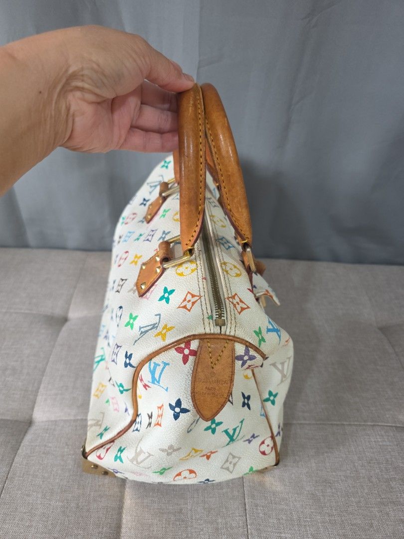 Louis Vuitton Monogram Multicolored Speedy (Category: Luxury Bags & Wallets) located in Binan City. Submitted by karosellescloset (Listing ID 1467663390, Image 2). Description: Louis Vuitton Monogram Multicolore Speedy 30 in White. ​Key features of this model include: ​ ​Material: White coated canvas featuring 33 distinct colors in the LV monogram pattern, with natural cowhide leather (vachetta) trim and top handles. ​Hardware: Gold-tone hardware