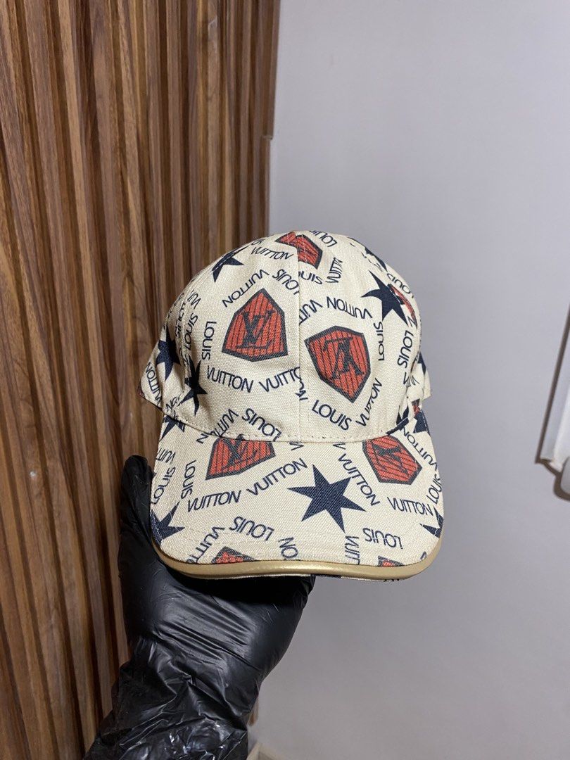 Louis Vuitton Monogram Shield Baseball Cap (Category: Caps & Hats) located in Caloocan City. Submitted by heatedcaps4425 (Listing ID 1467800241, Image 1). Description: - Condition: Brand new with tag attached - Design: Beige with all-over Louis Vuitton text print, red shields, and navy blue stars - Material: 100% polyester - Details: Adjustable back strap with gold-tone hardware - Interior: Clean lining with a black sweatband - Origin: Made in It