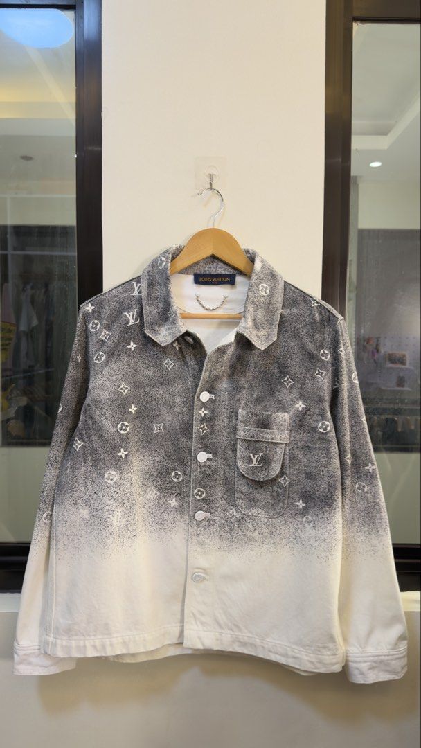 Louis Vuitton Monogram Spray Denim Jacket (Category: Coats, Jackets and Outerwear) located in Paranaque City. Submitted by mykapoynton (Listing ID 1467807799, Image 2). Description: Louis Vuitton Monogram Spray Denim Jacket - Size: S - Material: 100% Cotton (Made in Italy) - Design: Gradient grey and white spray effect with all-over classic monogram pattern - Details: Metal chain inside the collar, LV engraved buttons, and single chest pocket wit