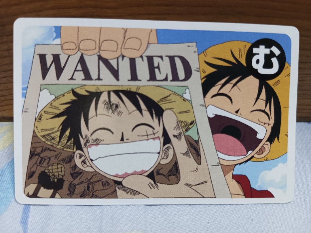 Luffy (Category: Raw Singles) located in Manila. Submitted by glique30 (Listing ID 1467690042, Image 1). Description: One Piece Karuta P800 MOD | LBC - Character: Monkey D. Luffy (holding wanted poster) - Design: Repeated skull and crossbones pattern on the back - Quality: Rounded corners and clean edges - Perfect for One Piece fans and TCG collectors.
