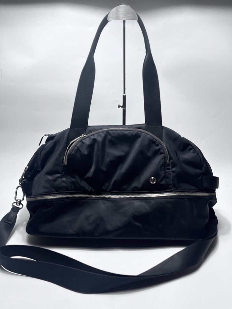 Lululemon Black Gym Duffel Bag (Category: Sling Bags) located in Iloilo. Submitted by fromthebins.ilo2 (Listing ID 1467750751, Image 1). Description: Black Lululemon duffel bag with sturdy shoulder straps and an adjustable crossbody strap. Silver-tone hardware and front zip pocket with the signature logo emblem. Roomy main compartment with a wraparound zipper. Bottom panel shows scuff marks and light wear from everyday use. Great size for workout