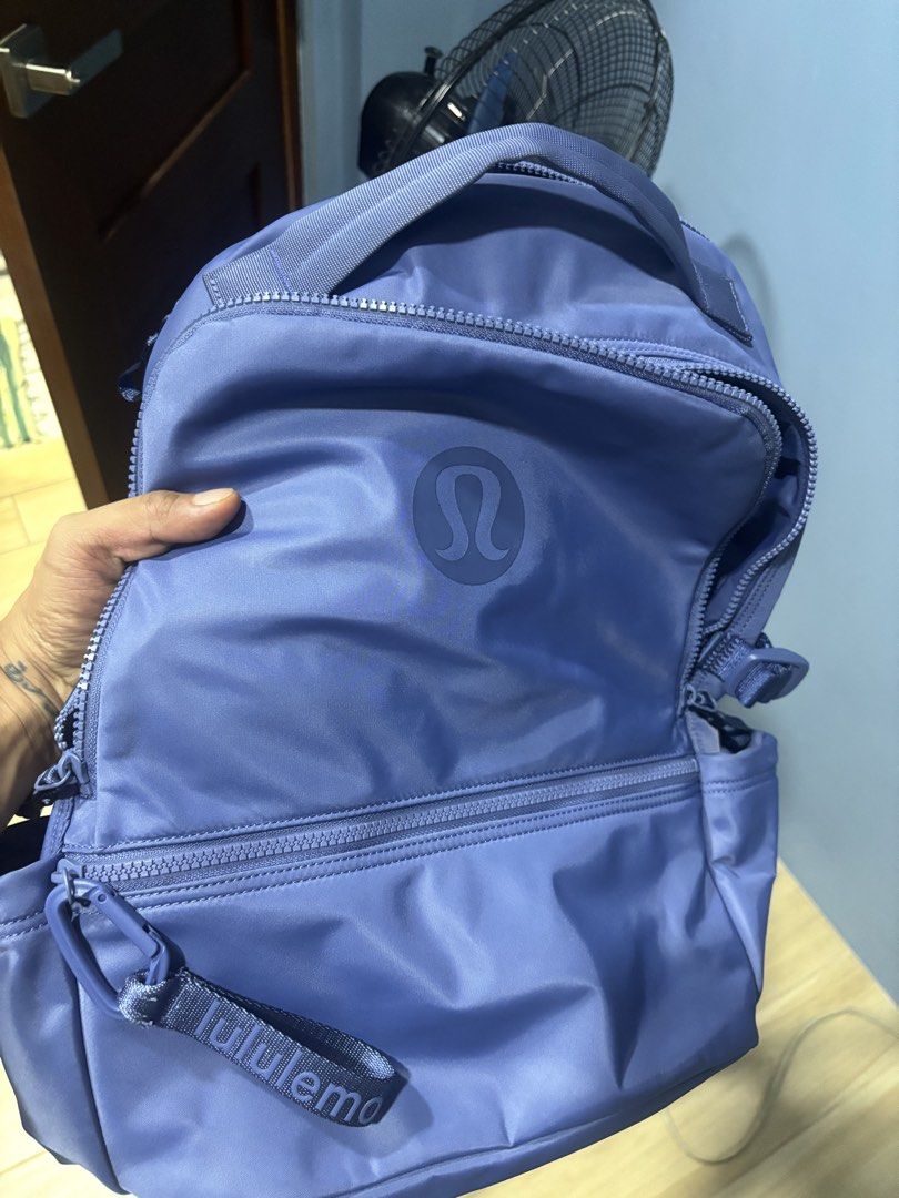 Lululemon Everyday Backpack Purple (Category: Backpacks) located in Tarlac. Submitted by aldrin328 (Listing ID 1467738491, Image 1). Description: - Brand: Lululemon - Color: Vibrant Purple - Material: Clean, durable nylon - Compartments: Multiple exterior zip compartments - Interior Storage: Mesh interior pocket and separate padded zip sleeve - Comfort: Padded top handle and fully adjustable straps - Ideal Use: Great daily carry for work, school,