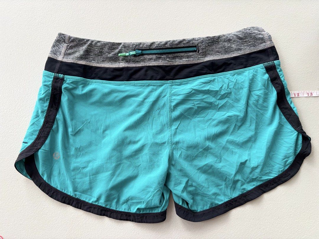 Lululemon running Shorts Teal Grey Black (Category: Activewear) located in Iloilo. Submitted by oddforest.c9c7d5 (Listing ID 1467647609, Image 2). Description: - Brand: Lululemon - Colorway: Teal, grey, and black - Design: Wide contrast waistband with secure back zip pocket - Features: Built-in liner brief with convenient inner pockets and reflective logo on leg hem - Material: Lightweight and breathable fabric - Ideal for: Running, workouts, gym