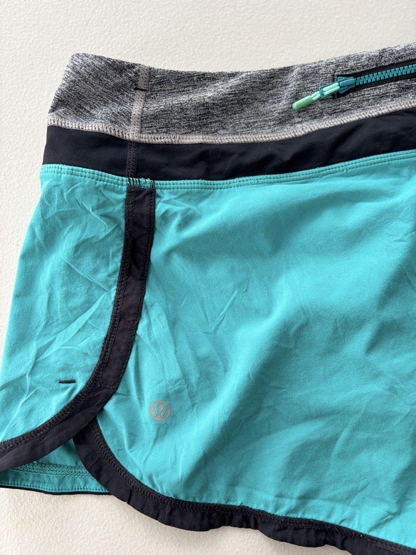 Lululemon running Shorts Teal Grey Black (Category: Activewear) located in Iloilo. Submitted by oddforest.c9c7d5 (Listing ID 1467647609, Image 3). Description: - Brand: Lululemon - Colorway: Teal, grey, and black - Design: Wide contrast waistband with secure back zip pocket - Features: Built-in liner brief with convenient inner pockets and reflective logo on leg hem - Material: Lightweight and breathable fabric - Ideal for: Running, workouts, gym