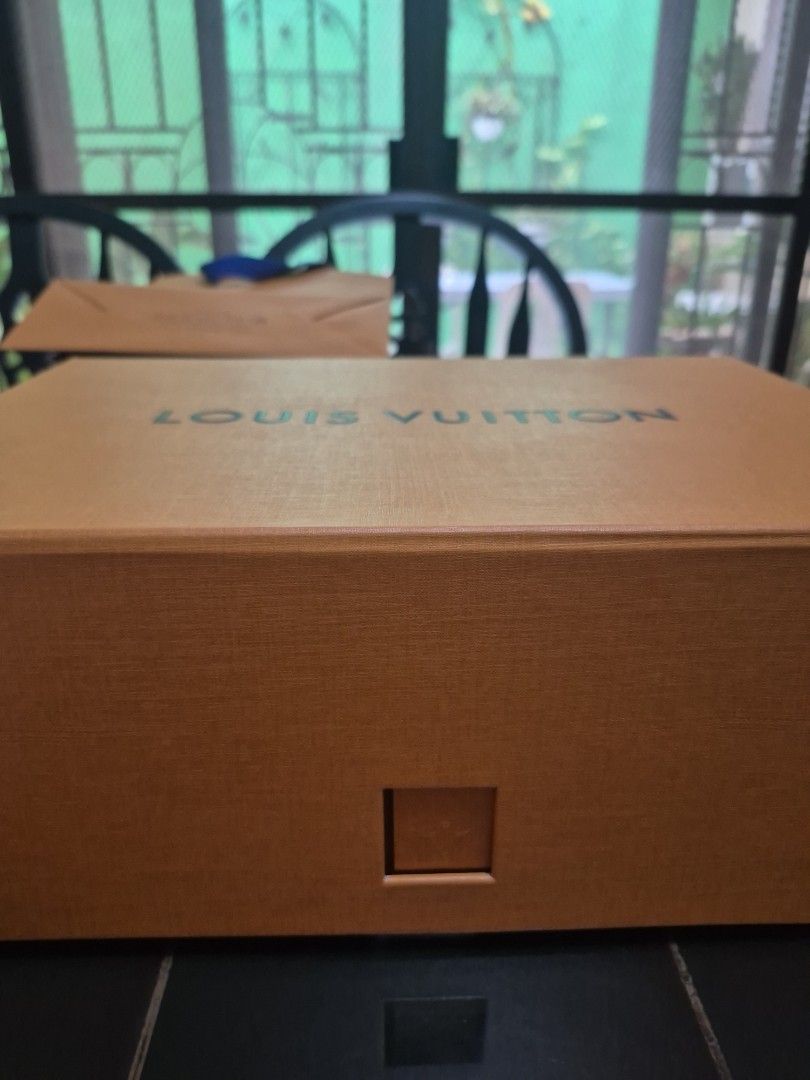 LV box for shoes/bag (Category: Luxury Accessories) located in Paranaque City. Submitted by amymaddy (Listing ID 1467608111, Image 1). Description: - Authentic Louis Vuitton branded box suitable for shoes or bags - Classic orange color with distinct LV typography - Sturdy and durable construction for safe storage ,10x14x5 inches This is the new version of box with diecut in square and locked in. Got this in France.