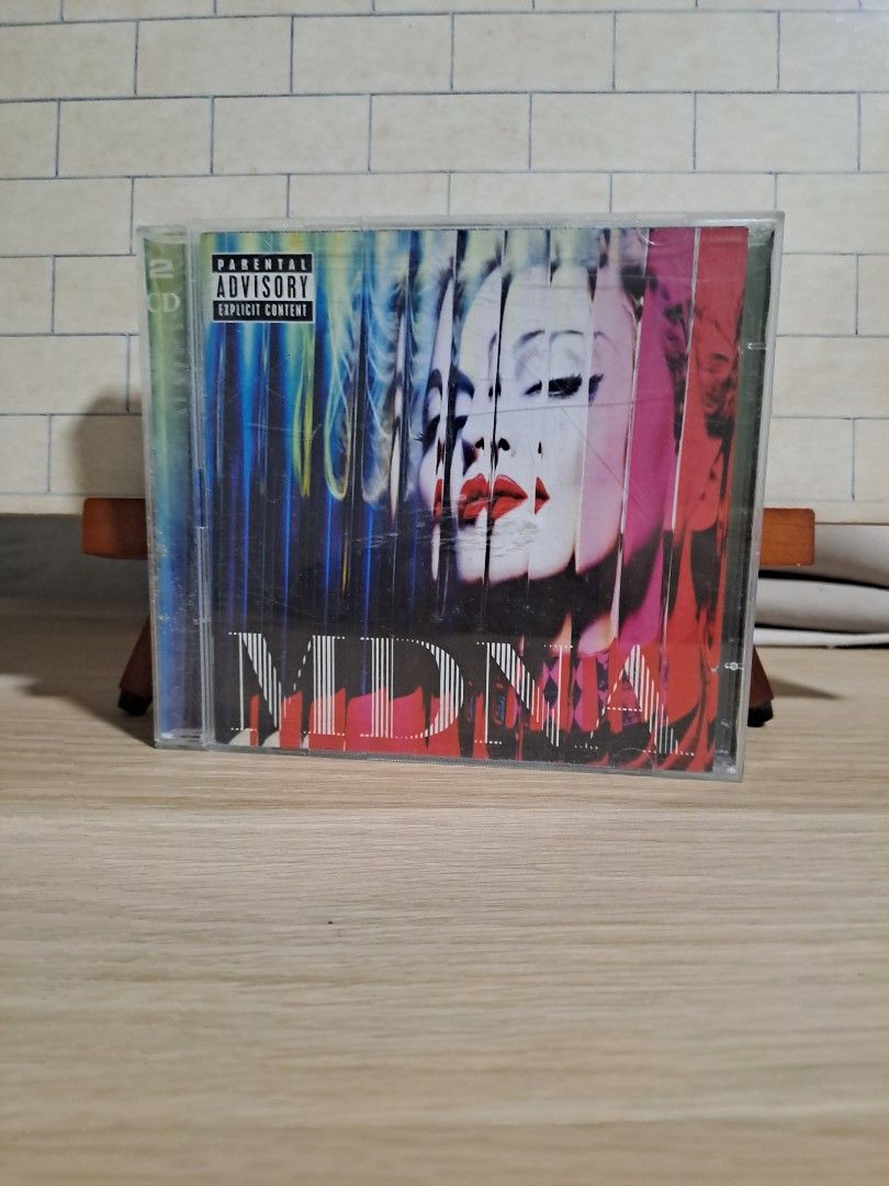 Madonna MDNA 2CD Album (Category: CDs & DVDs) located in Las Pinas. Submitted by cobieshop (Listing ID 1467770180, Image 1). Description: - Artist & Album: Madonna - MDNA (Double CD) - Format: Standard jewel case with Parental Advisory label - Cover Art: Features the iconic distorted facial image with red lips - Condition: Case has light surface scuffs from normal handling - Perfect for Madonna fans and physical media collectors.