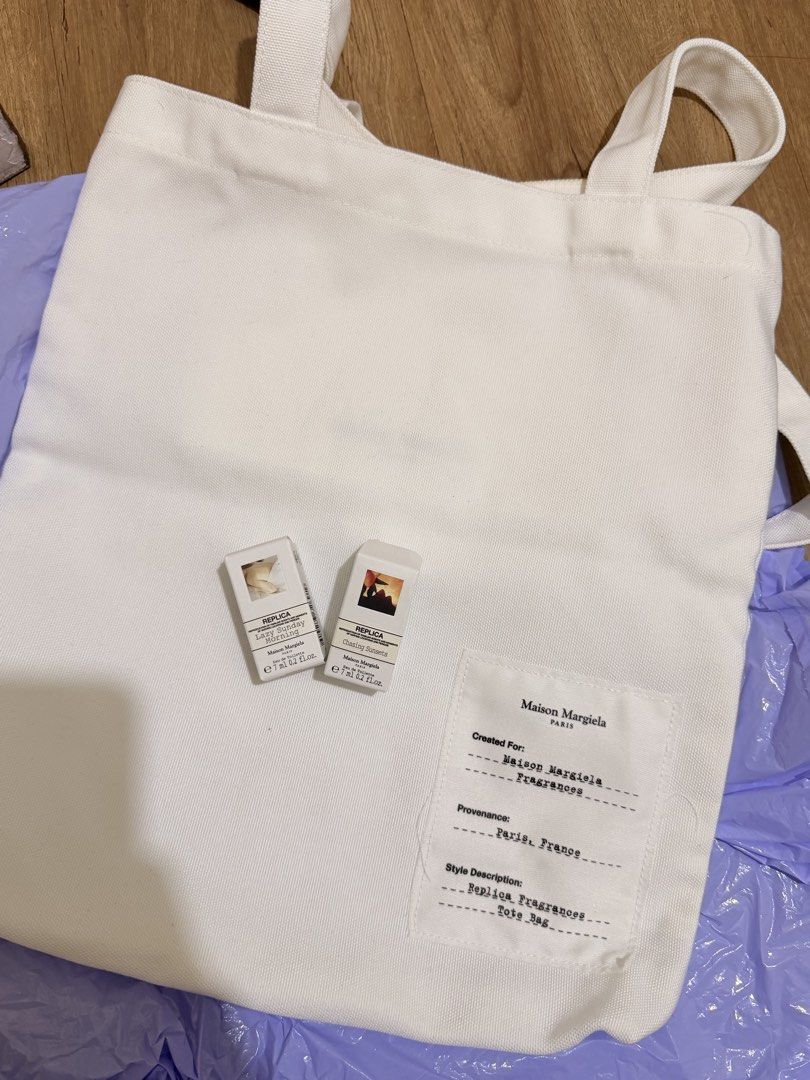 Maison Margiela Replica Fragrances Tote Bag & Samples (Category: Tote Bags) located in Manila. Submitted by scimihx (Listing ID 1464635413, Image 2). Description: - Includes 2 Replica fragrance samples: Lazy Sunday Morning & Chasing sunsets - Ideal set for experiencing Maison Margiela scents - Bag features a printed label on the front pocket.