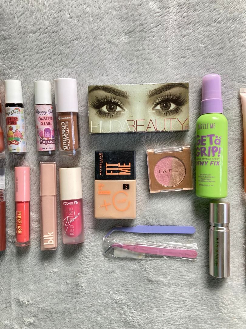 Makeup bundle (Take All) (Category: Makeup) located in Rizal. Submitted by sheeraay (Listing ID 1467708225, Image 1). Description: - 25-piece massive makeup bundle - Includes popular brands: Maybelline Fit Me, Huda Beauty, Dazzle Me, Happy Skin, and more - Product assortment: Liquid contours, water tints, setting sprays, eyeshadows, primers, lip glosses, eyeliner pencils, tweezers, and highlighters - Ideal as a starter kit or to expand your curre
