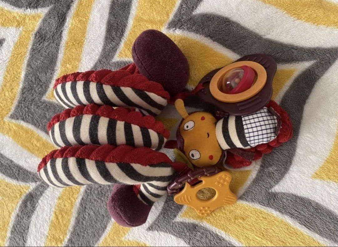 Mamas & Papas Stroller Spiral Activity Toy (Category: Infant Playtime) located in Quezon City. Submitted by littleparties (Listing ID 1467759600, Image 3). Description: - Brand: Mamas & Papas - Design: Red, black, and white stripe spiral activity toy - Features: Wraps easily around stroller bars, car seats, or cots - Toys included: Squeaky bee character, yellow star teether, and rattling mirror - Material: Soft textured fabrics - Condition: Clean