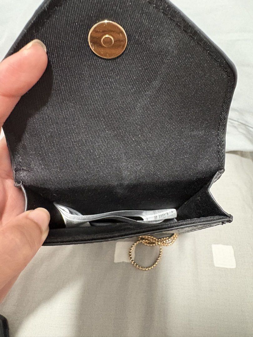 Mango Black Croc Effect Phone Pouch Crossbody Bag (Category: Cross-body Bags) located in Quezon City. Submitted by everything99_ (Listing ID 1467774764, Image 3). Description: - Brand: Mango (Original store tag attached, Model: FUNDA P 75ILEONOR) - Color & Finish: Sleek black with a trendy crocodile texture - Hardware: Elegant gold-tone accents including the front MNG logo and slim chain strap - Closure: Secure flap with a magnetic snap button - 