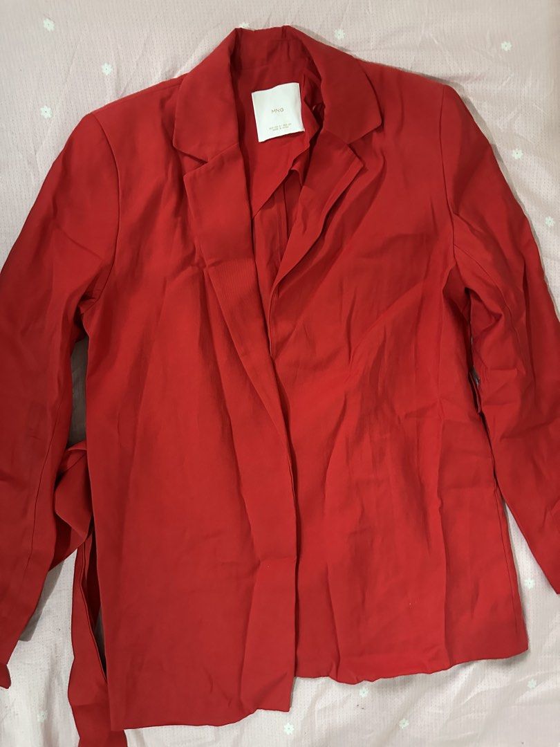MANGO Red Blazer Size S (Category: Coats, Jackets and Outerwear) located in Lipa City. Submitted by chiechums (Listing ID 1467640158, Image 2). Description: - Brand: MNG - Size: EUR/USA Small - Color: Bright red (great for a pop of color) - Material: Lightweight fabric with a slight drape - Design: Lapels, long sleeves, and built-in tie belt straps at the sides - Condition: Excellent, no major flaws spotted.