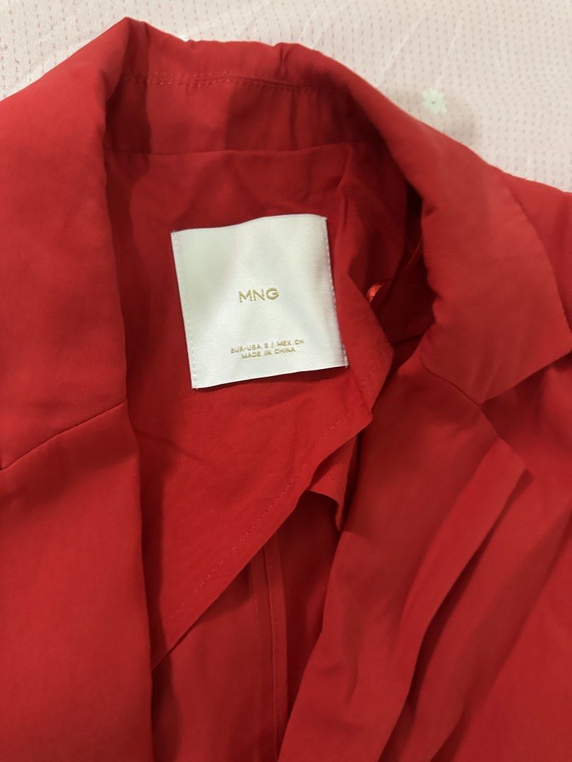 MANGO Red Blazer Size S (Category: Coats, Jackets and Outerwear) located in Lipa City. Submitted by chiechums (Listing ID 1467640158, Image 3). Description: - Brand: MNG - Size: EUR/USA Small - Color: Bright red (great for a pop of color) - Material: Lightweight fabric with a slight drape - Design: Lapels, long sleeves, and built-in tie belt straps at the sides - Condition: Excellent, no major flaws spotted.