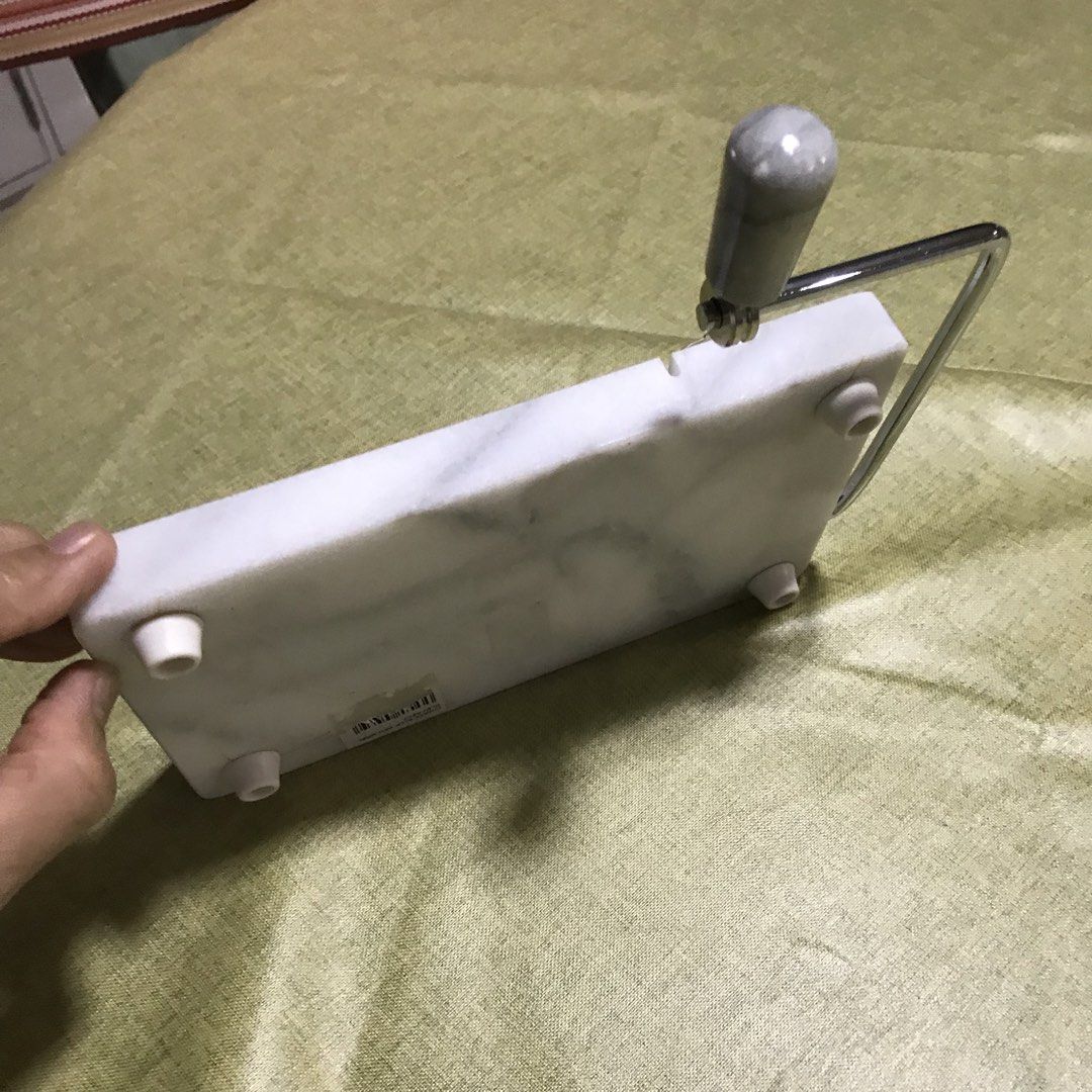 Marble Cheese Slicer and Serving Tray (Category: Knives & Chopping Boards) located in Manila. Submitted by magimi (Listing ID 1467753142, Image 2). Description: - Elegant white and gray marble cheese slicer, measuring 8 x 5 inches - Durable steel arm with a matching marble handle for smooth slicing - Equipped with rubber feet on the bottom to protect your countertops from scratches - Perfect for achieving clean slices on both hard and soft cheese