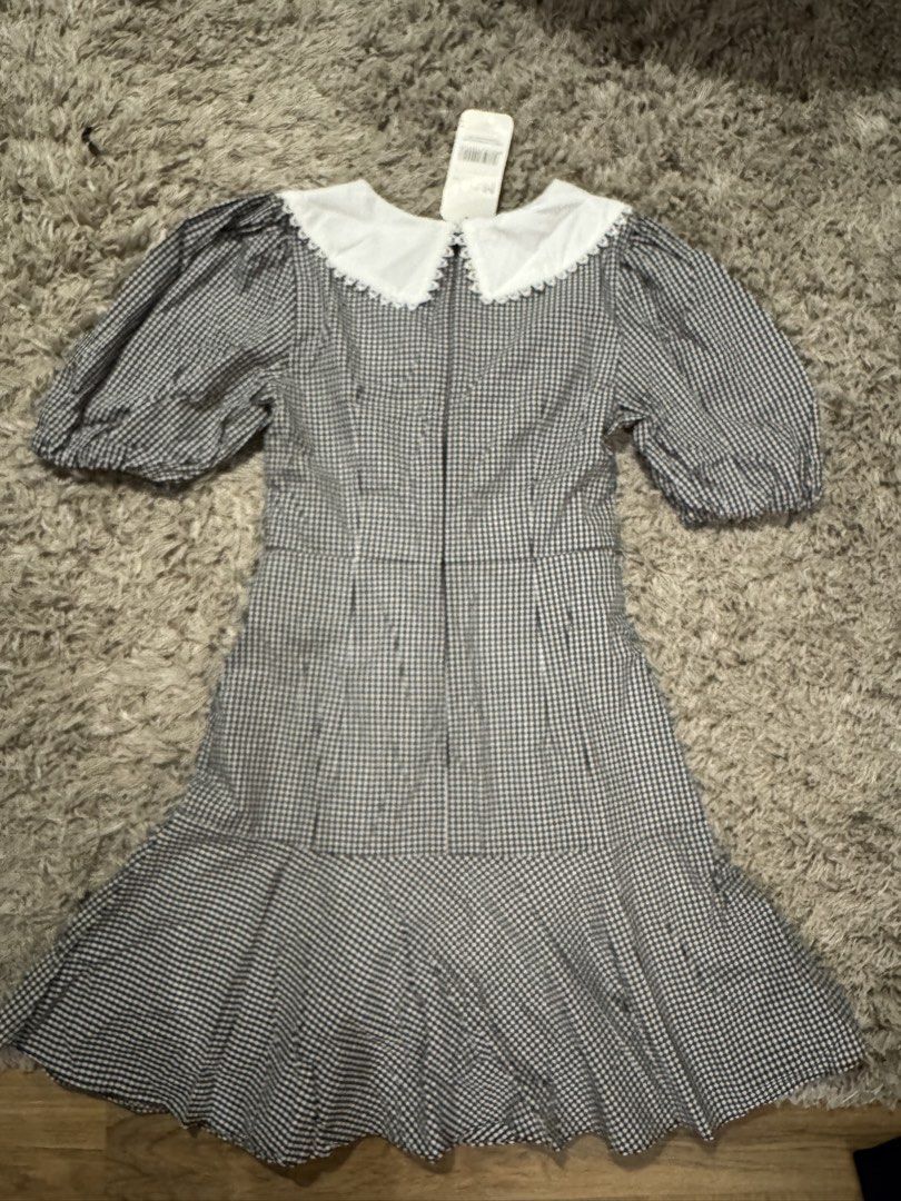 MARC Black White Gingham Peter Pan Collar Dress (Category: Dresses) located in Caloocan City. Submitted by newcrystal_3b43ba (Listing ID 1467743341, Image 2). Description: - Brand: MARC - Condition: Brand new with original store tag - Pattern: Black and white gingham - Design details: Large white Peter Pan collar with lace trim, puff sleeves, and flared ruffle hem - Closure: Back zipper.
